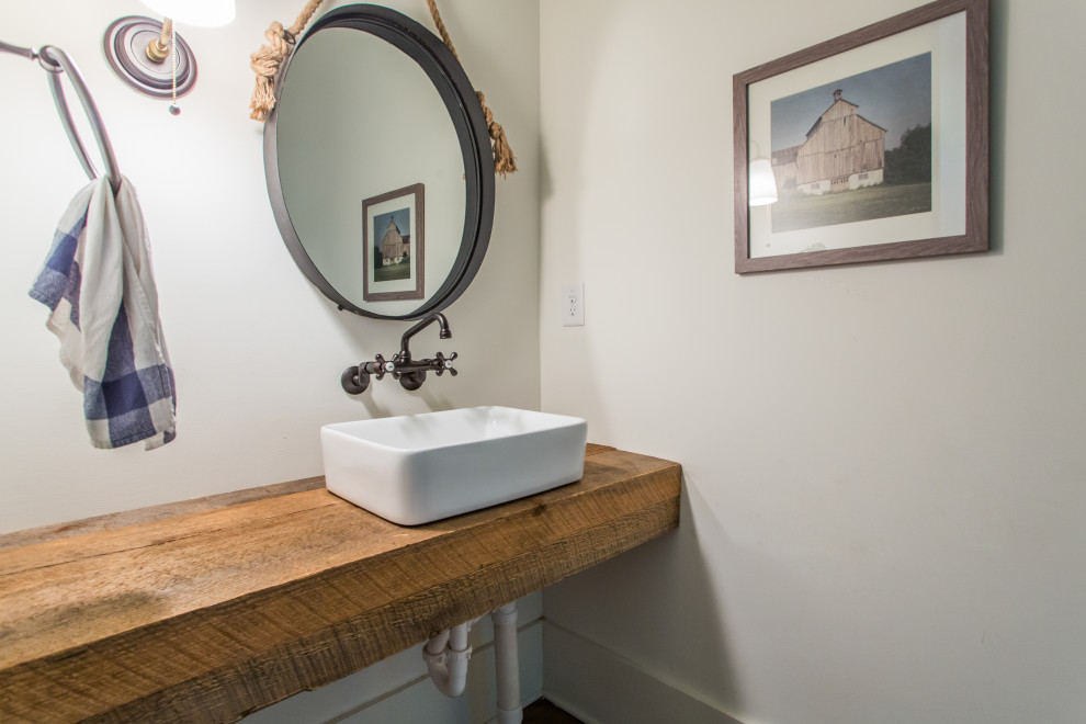 Example of a country white tile dark wood floor and single-sink bathroom design in Atlanta with medium tone wood cabinets, white walls, a vessel sink, wood countertops, brown countertops and a floating vanity