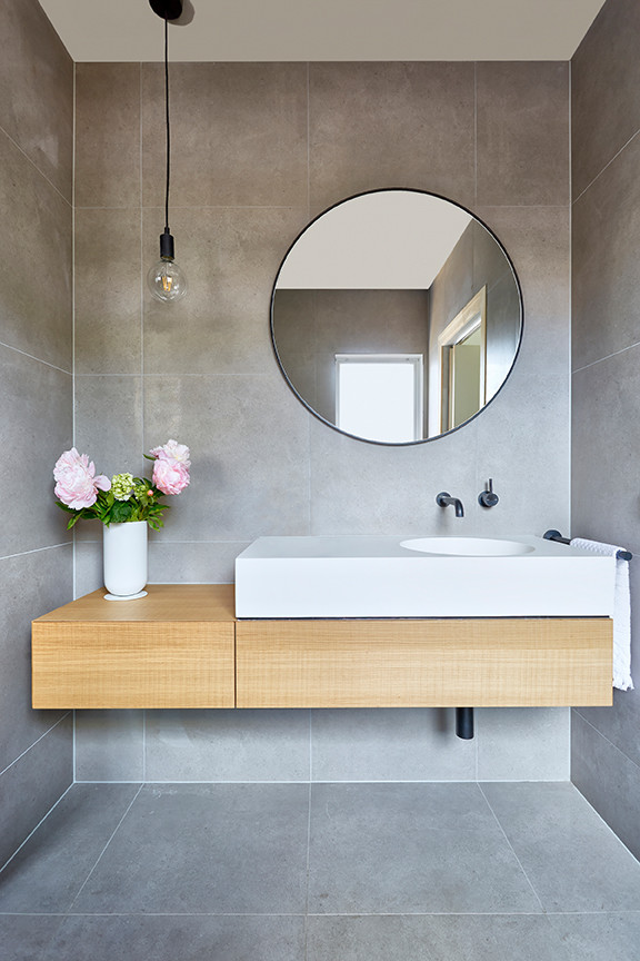 Inspiration for a large contemporary ensuite bathroom in Melbourne with open cabinets, light wood cabinets, a freestanding bath, a walk-in shower, stone slabs, slate flooring, a built-in sink and wooden worktops.