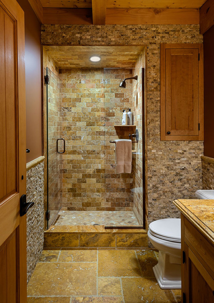 Cette image montre une grande salle de bain principale design en bois brun avec un placard avec porte à panneau encastré, une baignoire posée, une douche d'angle, un carrelage gris, des carreaux de céramique, un mur gris, un sol en carrelage de céramique et un plan de toilette en granite.