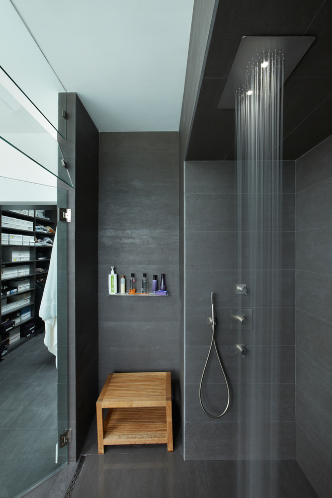 Inspiration for a modern bathroom in Los Angeles with a built-in shower and grey tiles.