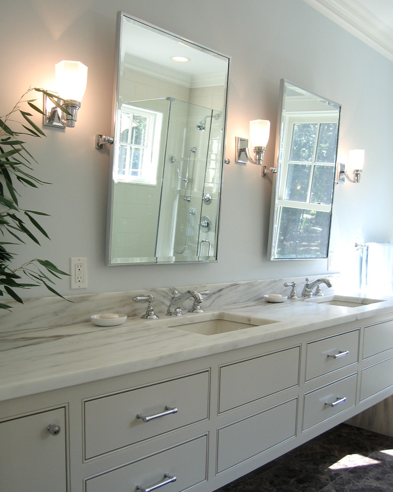 This is an example of a medium sized traditional ensuite bathroom in New York with a submerged sink, flat-panel cabinets, white cabinets, marble worktops and purple walls.