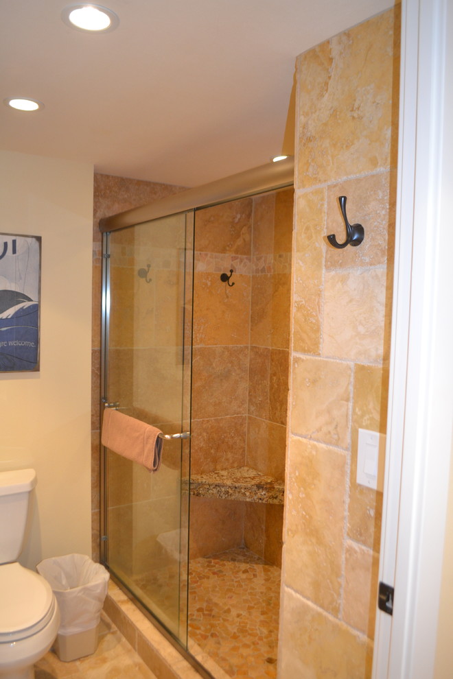 Inspiration for a mid-sized craftsman 3/4 beige tile terra-cotta tile alcove shower remodel in Hawaii with a two-piece toilet and beige walls