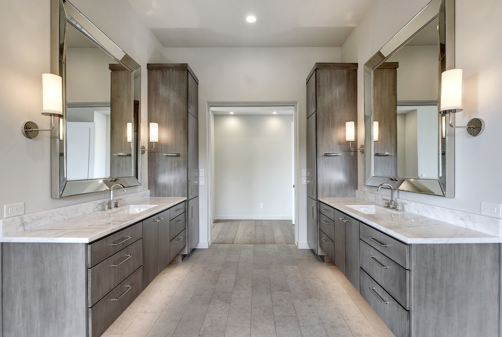 Inspiration for an expansive classic ensuite bathroom in Austin with flat-panel cabinets, grey cabinets, a freestanding bath, a double shower, a one-piece toilet, white walls, limestone flooring, a submerged sink, marble worktops, grey floors, a hinged door and white worktops.
