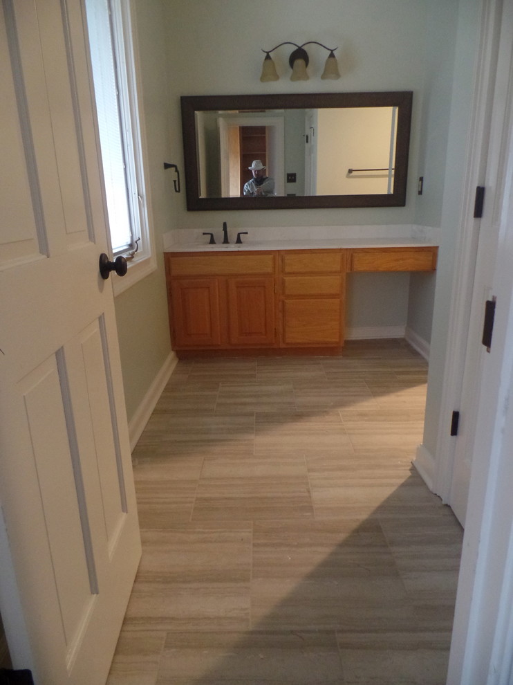 Mid-sized transitional kids' multicolored tile and porcelain tile porcelain tile bathroom photo in Other with raised-panel cabinets, light wood cabinets, a two-piece toilet, green walls, an integrated sink and solid surface countertops