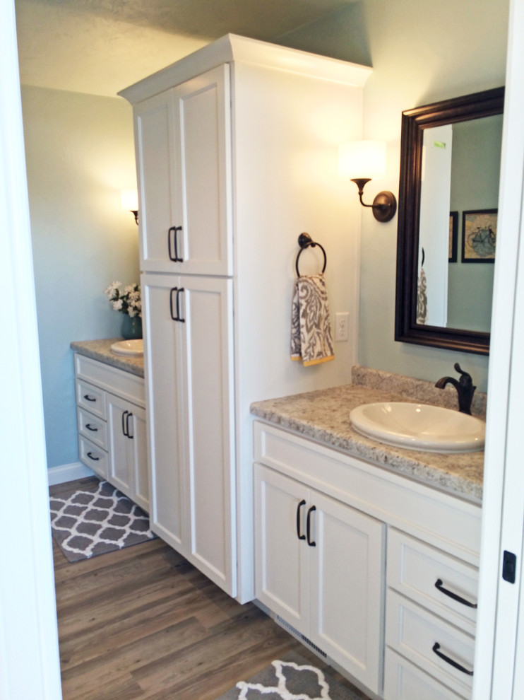 Design ideas for a medium sized contemporary ensuite bathroom in Milwaukee with a built-in sink, shaker cabinets, white cabinets, laminate worktops and an alcove shower.