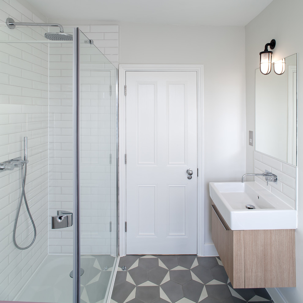 This is an example of a medium sized contemporary bathroom in London with a freestanding bath, white tiles, ceramic tiles, white walls, ceramic flooring, a console sink, grey floors and an open shower.
