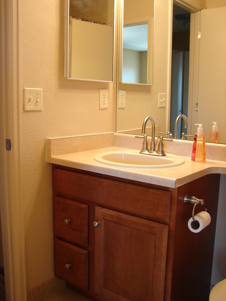 Transitional bathroom photo in Denver with a drop-in sink, recessed-panel cabinets and medium tone wood cabinets