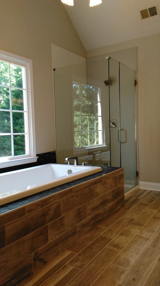 Bild på ett mellanstort funkis en-suite badrum, med ett platsbyggt badkar, beige väggar, klinkergolv i porslin, brunt golv, en hörndusch och dusch med gångjärnsdörr