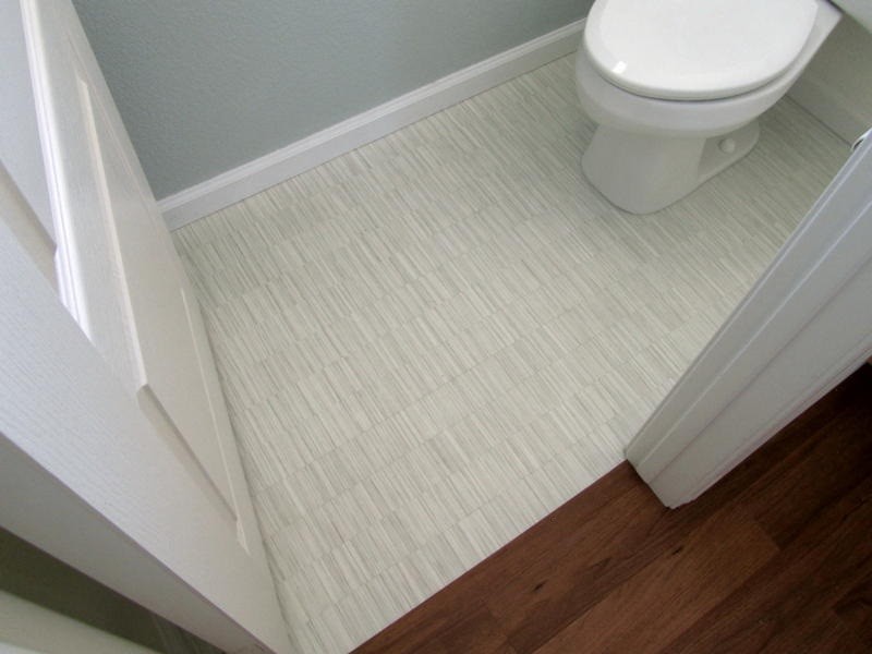 Modelo de cuarto de baño tradicional renovado pequeño con sanitario de una pieza, paredes grises, suelo vinílico, aseo y ducha y suelo beige