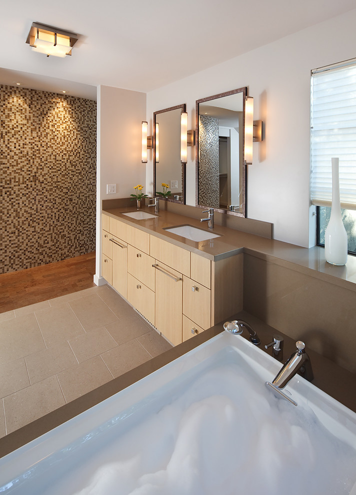 Imagen de cuarto de baño minimalista con lavabo bajoencimera, armarios con paneles lisos, puertas de armario de madera clara y paredes blancas