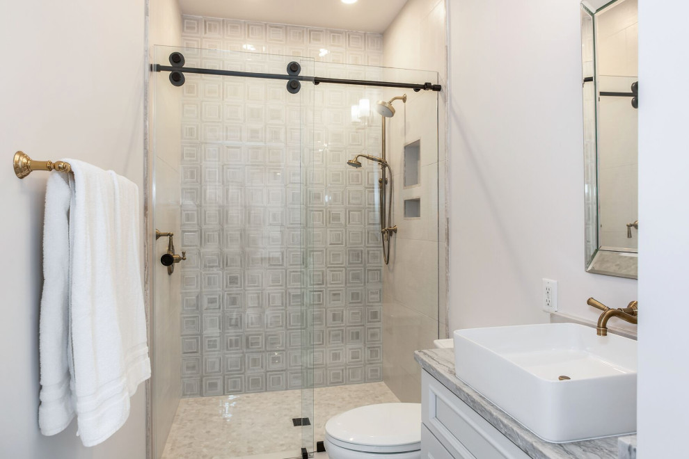 Example of a mid-sized transitional 3/4 mosaic tile floor, gray floor and single-sink bathroom design in Wilmington with raised-panel cabinets, gray cabinets, a two-piece toilet, gray walls, a vessel sink, granite countertops, a niche and a built-in vanity