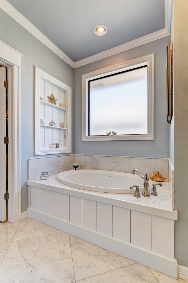 Inspiration for a large traditional ensuite bathroom in Oklahoma City with freestanding cabinets, grey cabinets, a built-in bath, an alcove shower, a two-piece toilet, grey tiles, white tiles, stone tiles, grey walls, marble flooring, a submerged sink and engineered stone worktops.