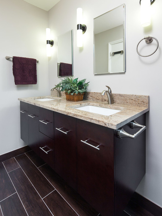 This is an example of a medium sized traditional ensuite bathroom in Chicago with flat-panel cabinets, dark wood cabinets, an alcove shower, a two-piece toilet, multi-coloured tiles, stone tiles, grey walls, porcelain flooring, a submerged sink and granite worktops.
