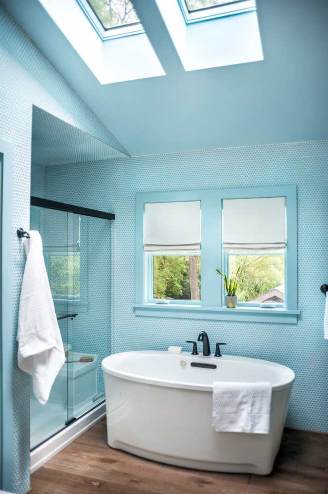 На фото: главная ванная комната среднего размера в современном стиле с синей плиткой, синими стенами, паркетным полом среднего тона, отдельно стоящей ванной, душем в нише, коричневым полом и душем с раздвижными дверями с
