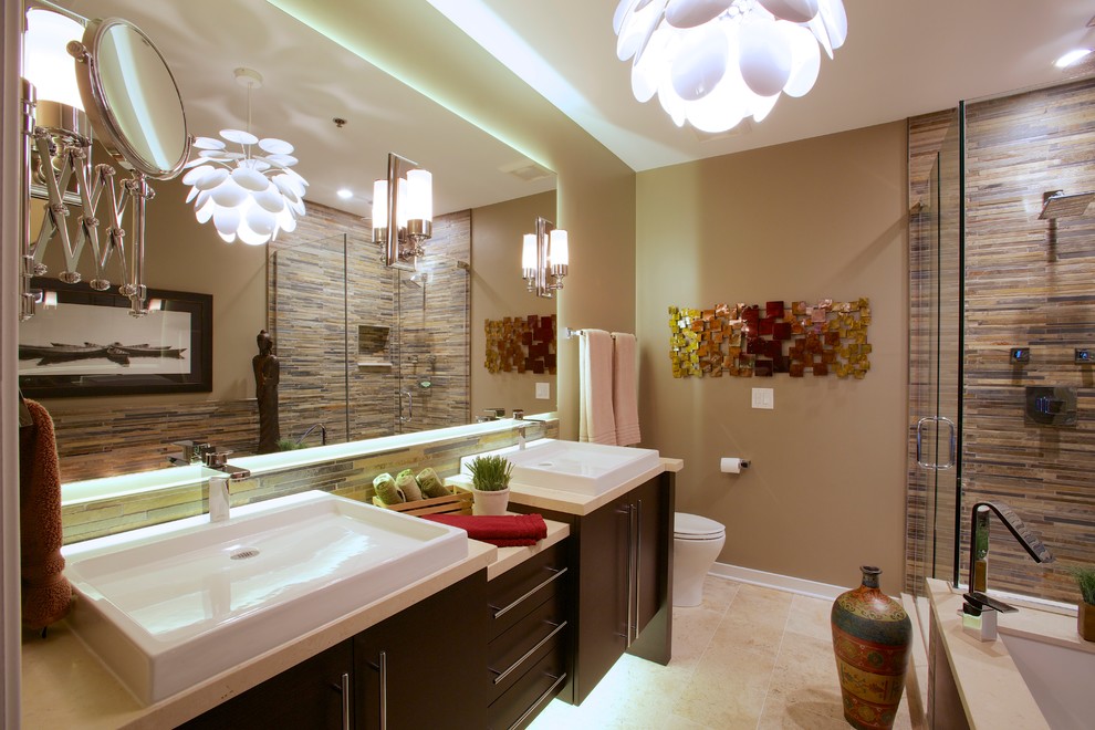 Large trendy master multicolored tile travertine floor and beige floor bathroom photo in Chicago with flat-panel cabinets, dark wood cabinets, a two-piece toilet, brown walls, a vessel sink and a hinged shower door