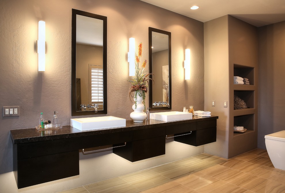 Example of a large trendy master porcelain tile and beige floor bathroom design in Other with flat-panel cabinets, black cabinets, gray walls, a vessel sink, granite countertops, a hinged shower door and black countertops