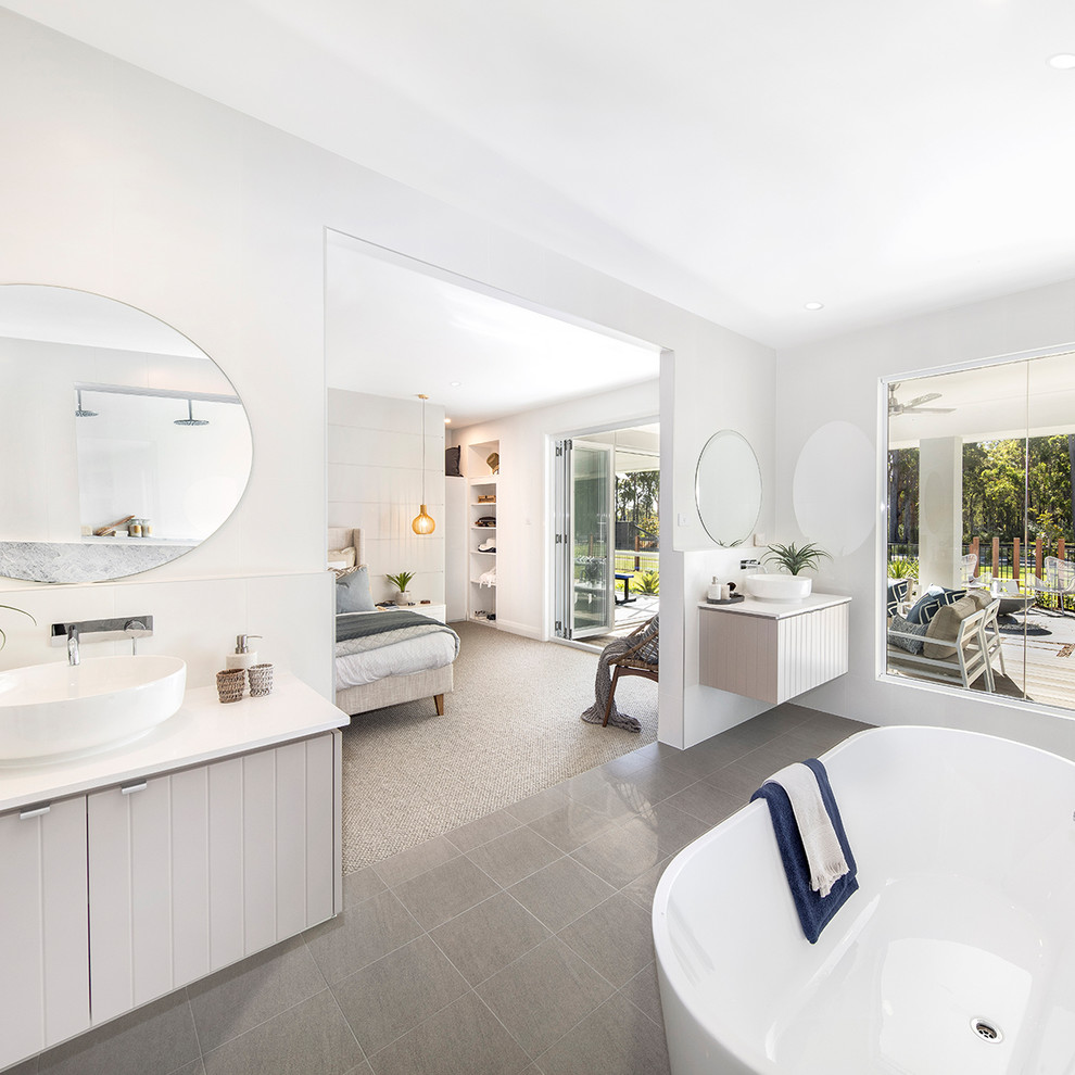 This is an example of a large coastal ensuite bathroom in Sydney with shaker cabinets, white cabinets, a corner shower, white tiles, ceramic tiles, white walls, cement flooring, a submerged sink, marble worktops, green floors, a hinged door and white worktops.