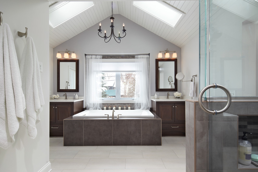 Elegant master bathroom photo in Minneapolis with an undermount sink, dark wood cabinets and quartz countertops