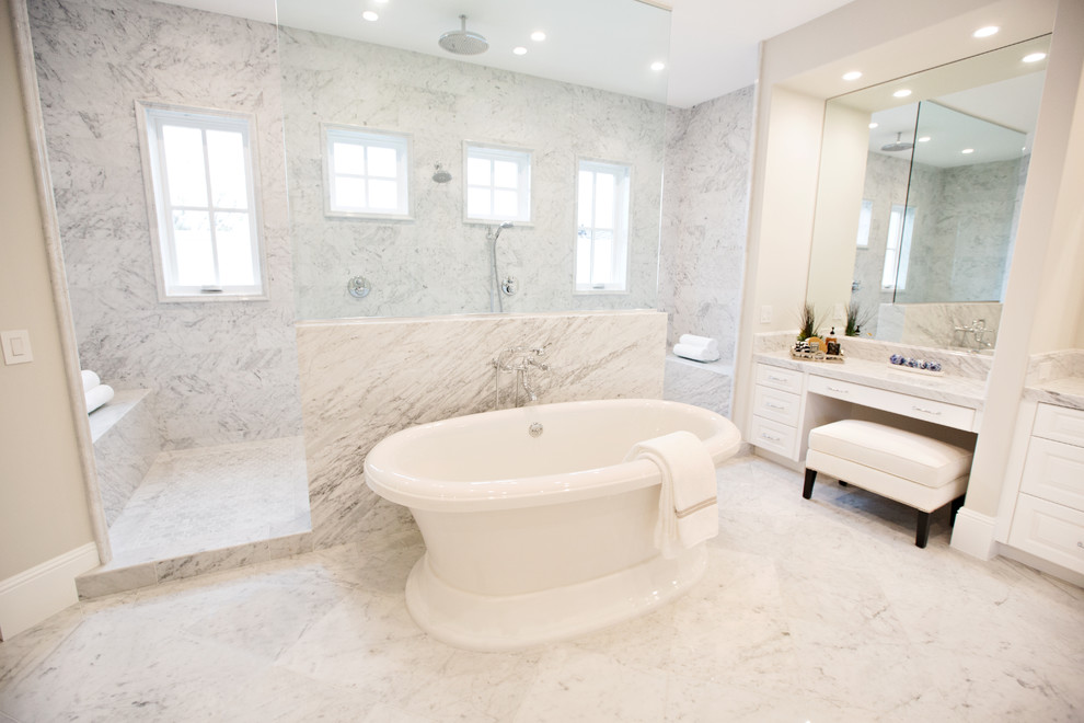 Example of a large transitional master gray tile marble floor bathroom design in Orange County with raised-panel cabinets, white cabinets, beige walls, an undermount sink and marble countertops