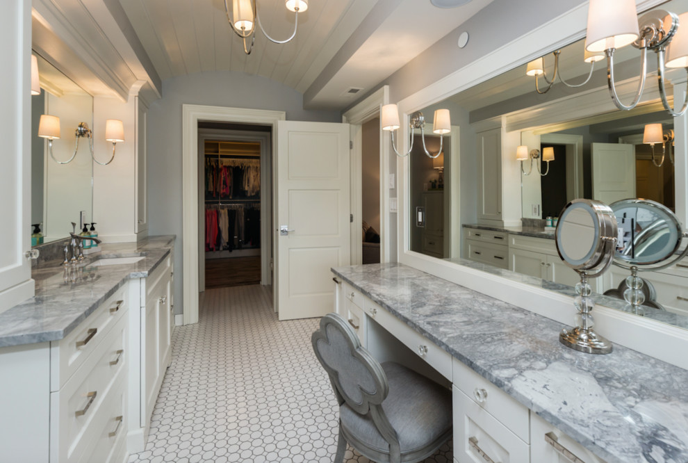 Inspiration for a large traditional ensuite bathroom in Other with flat-panel cabinets, white cabinets, a built-in bath, grey tiles, grey walls, cement flooring, a built-in sink and granite worktops.