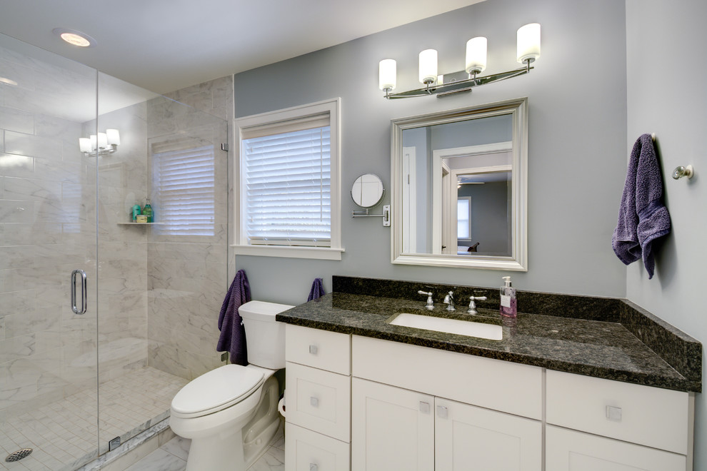 Example of a mid-sized classic master white tile and ceramic tile marble floor double shower design in Detroit with an undermount sink, recessed-panel cabinets, white cabinets, quartz countertops, a two-piece toilet and blue walls