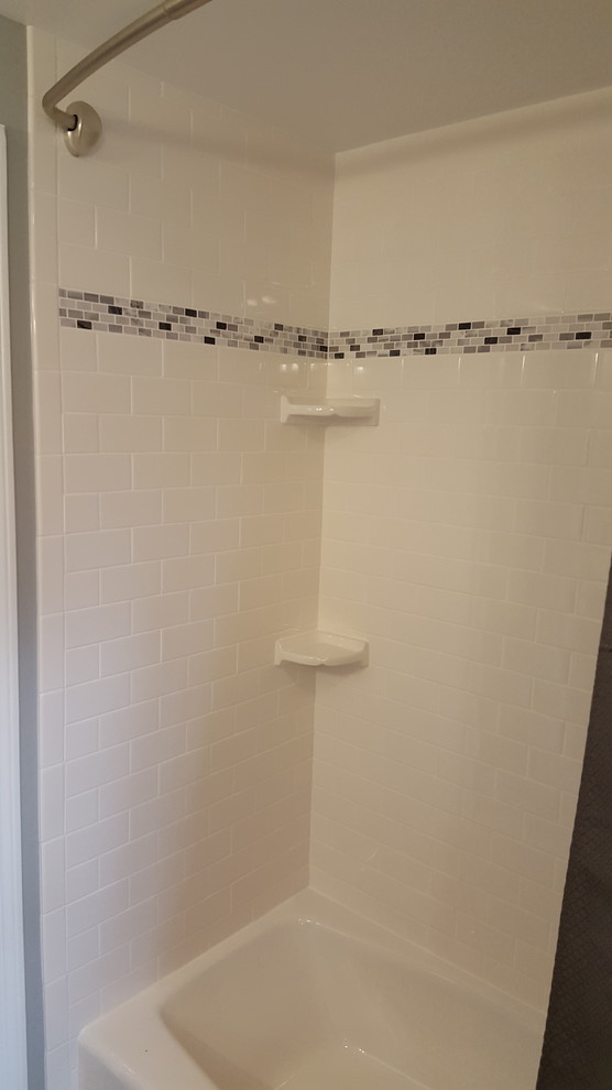 Example of a mid-sized classic kids' white tile and subway tile ceramic tile bathroom design in Detroit with recessed-panel cabinets, dark wood cabinets, a two-piece toilet, gray walls, an integrated sink and solid surface countertops