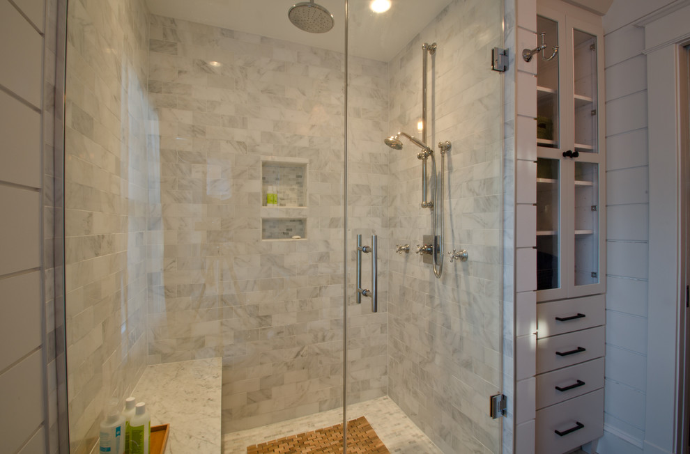 Mid-sized elegant master white tile and stone tile ceramic tile alcove shower photo in DC Metro with an undermount sink, glass-front cabinets, white cabinets, marble countertops, a two-piece toilet and white walls