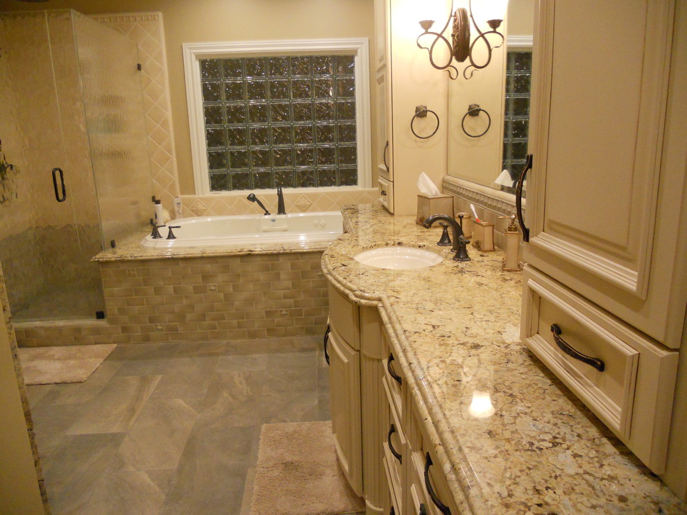 Example of a large classic master beige tile and ceramic tile slate floor and gray floor bathroom design in San Francisco with raised-panel cabinets, beige cabinets, a two-piece toilet, beige walls, an undermount sink, granite countertops, a hinged shower door and beige countertops