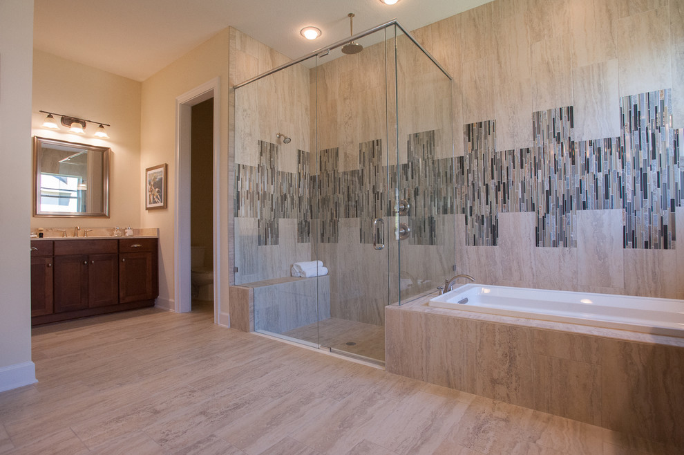Inspiration for a large traditional ensuite bathroom in Jacksonville with flat-panel cabinets, brown cabinets, an alcove bath, a corner shower, a one-piece toilet, beige tiles, ceramic tiles, beige walls, ceramic flooring, a built-in sink and soapstone worktops.