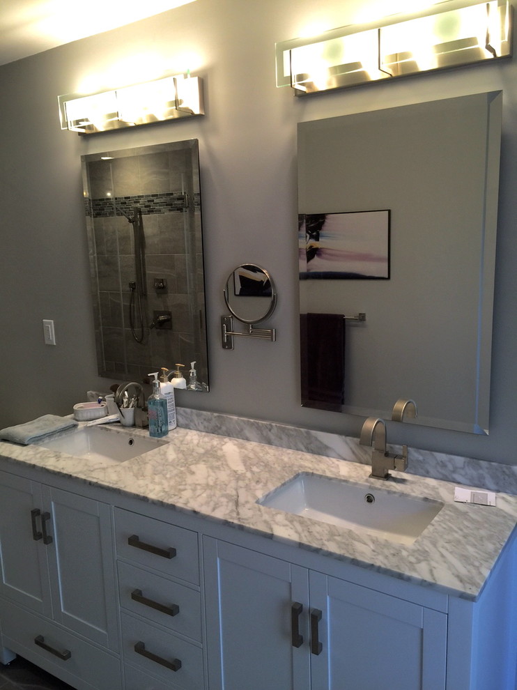 Inspiration for a small contemporary master gray tile and ceramic tile ceramic tile doorless shower remodel in Raleigh with recessed-panel cabinets, white cabinets, marble countertops, a one-piece toilet, an undermount sink and gray walls