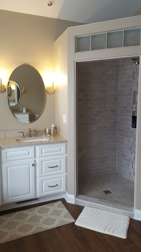 Photo of an expansive classic bathroom in Other with raised-panel cabinets, white cabinets and porcelain flooring.