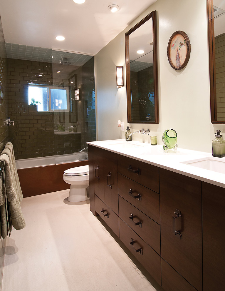 Mid-sized trendy master ceramic tile concrete floor bathroom photo in Phoenix with furniture-like cabinets, dark wood cabinets, limestone countertops, a one-piece toilet and white walls