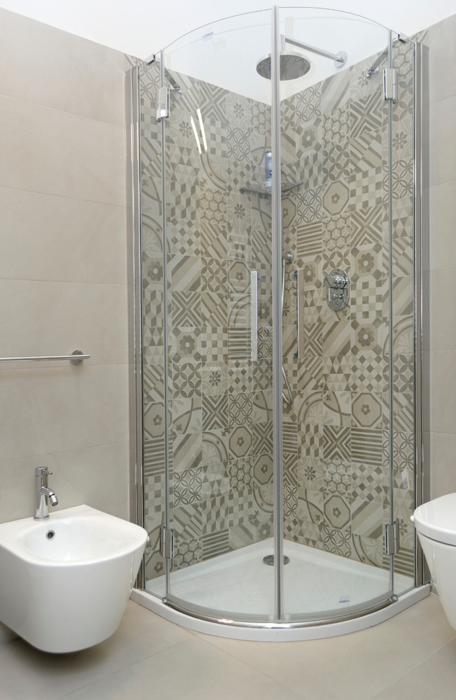 Corner shower - small contemporary master beige tile and ceramic tile ceramic tile corner shower idea in Milan with a wall-mount toilet and white walls