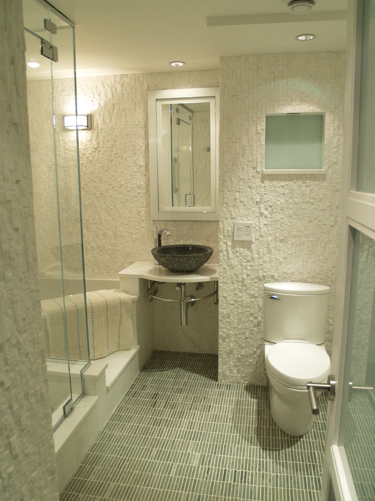 Design ideas for a medium sized traditional bathroom in New York with a vessel sink, a corner bath, a corner shower, a one-piece toilet, white walls, mosaic tile flooring and solid surface worktops.