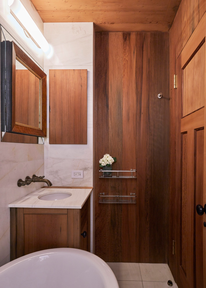 Exemple d'une petite salle de bain chic en bois brun avec un placard avec porte à panneau encastré, un carrelage blanc, du carrelage en marbre, un sol en marbre, un lavabo encastré, un plan de toilette en marbre et un sol blanc.