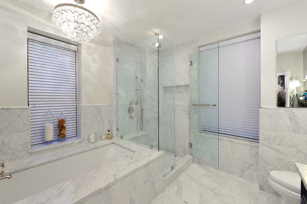 Inspiration for a large contemporary gray tile and stone tile marble floor bathroom remodel in New York with an integrated sink, raised-panel cabinets, dark wood cabinets, marble countertops, a two-piece toilet and white walls