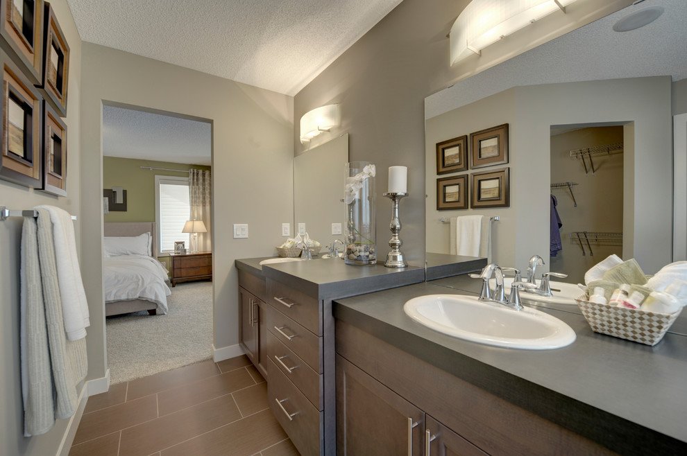 Medium sized classic ensuite bathroom in Edmonton with shaker cabinets, brown cabinets, a corner bath, an alcove shower, a one-piece toilet, beige tiles, beige walls, ceramic flooring, a built-in sink, laminate worktops, brown floors and a hinged door.