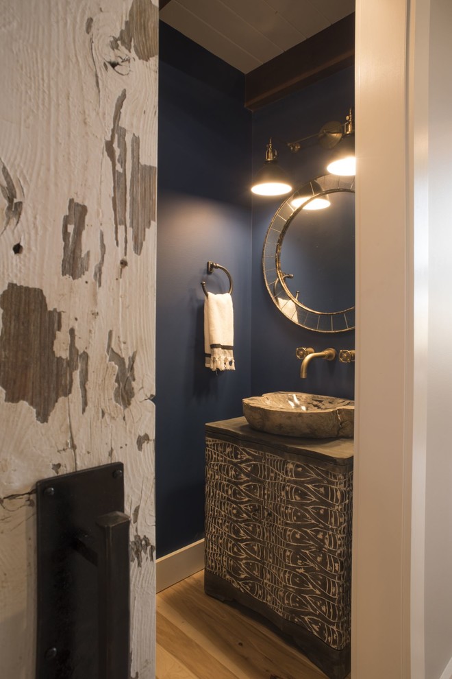 Photo of a medium sized contemporary shower room bathroom in Columbus with freestanding cabinets, distressed cabinets, blue walls, light hardwood flooring, an integrated sink, wooden worktops, brown floors and brown worktops.