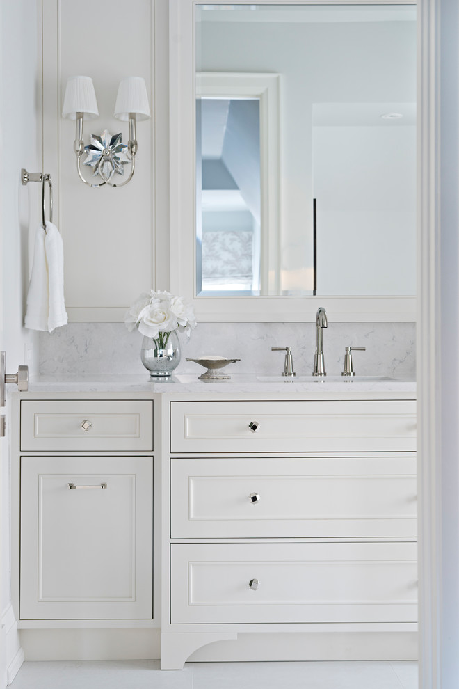 Inspiration for a mid-sized timeless master white tile and porcelain tile porcelain tile and gray floor bathroom remodel in Toronto with furniture-like cabinets, white cabinets, a one-piece toilet, white walls, an undermount sink, marble countertops, a hinged shower door and brown countertops