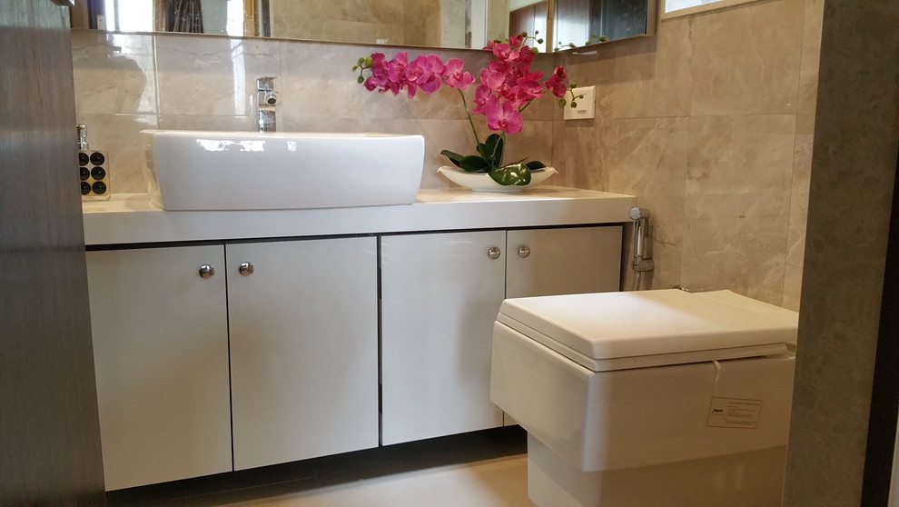 Photo of a medium sized contemporary ensuite bathroom in Mumbai with flat-panel cabinets, white cabinets and beige tiles.