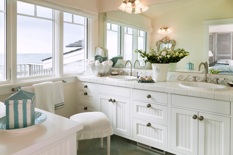 This is an example of a large coastal ensuite bathroom in San Francisco with white cabinets, tiled worktops, green tiles, ceramic tiles, a walk-in shower, a one-piece toilet, white walls, ceramic flooring and recessed-panel cabinets.