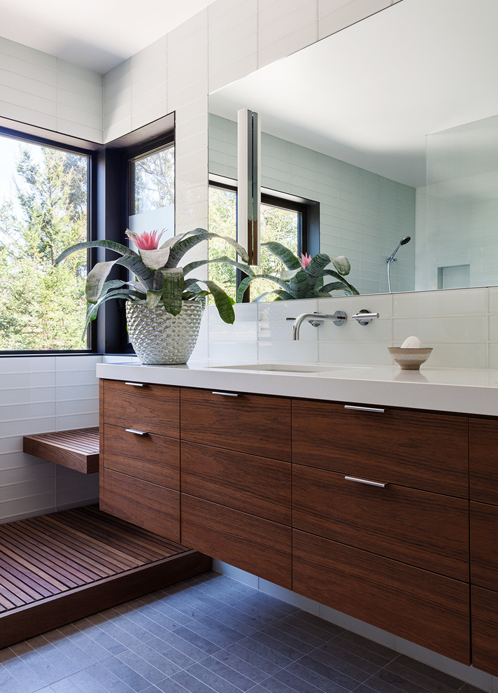 Design ideas for a contemporary bathroom in San Francisco with flat-panel cabinets, dark wood cabinets, white tiles, glass tiles, white walls, a submerged sink and grey floors.
