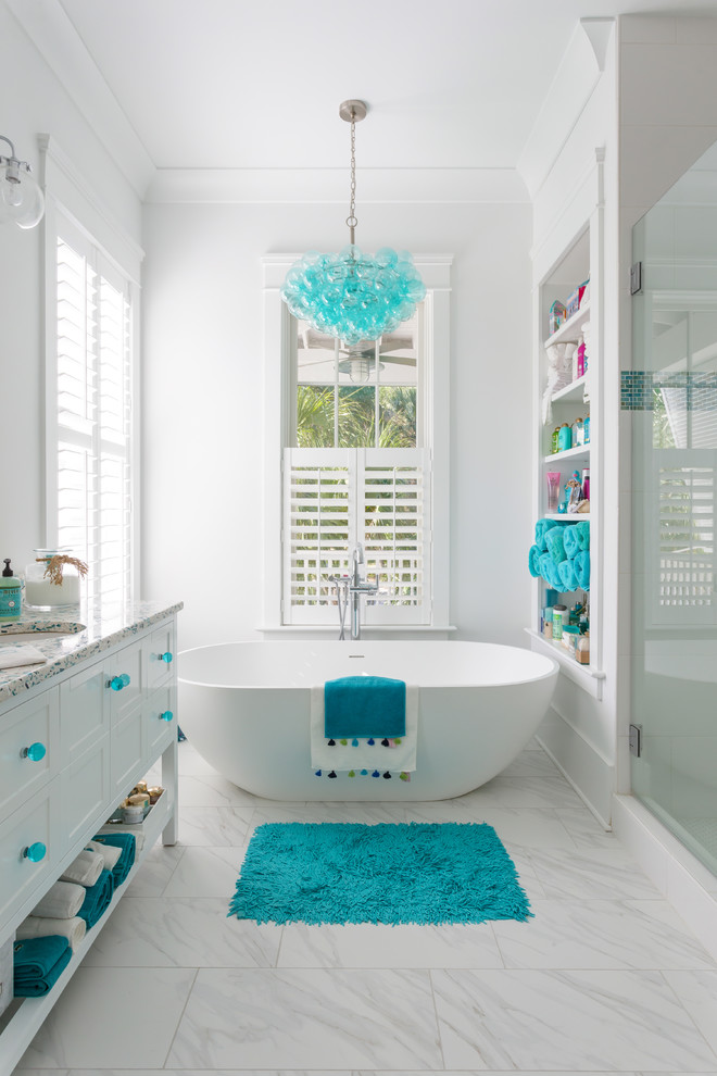 Photo of a small coastal ensuite bathroom in Charleston with white cabinets, a freestanding bath, white walls, terrazzo worktops, multi-coloured worktops, a submerged sink, white floors and shaker cabinets.