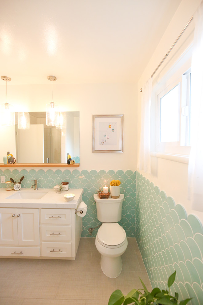 Example of a mid-sized eclectic kids' blue tile and ceramic tile tub/shower combo design in Sacramento with white cabinets and white walls