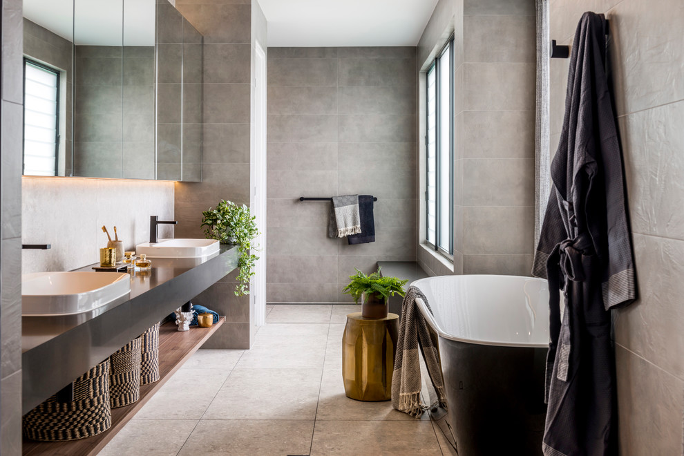 Idéer för att renovera ett stort funkis grå grått en-suite badrum, med ett fristående badkar, grå kakel, grå väggar, öppna hyllor, en kantlös dusch, ett nedsänkt handfat, grått golv och med dusch som är öppen