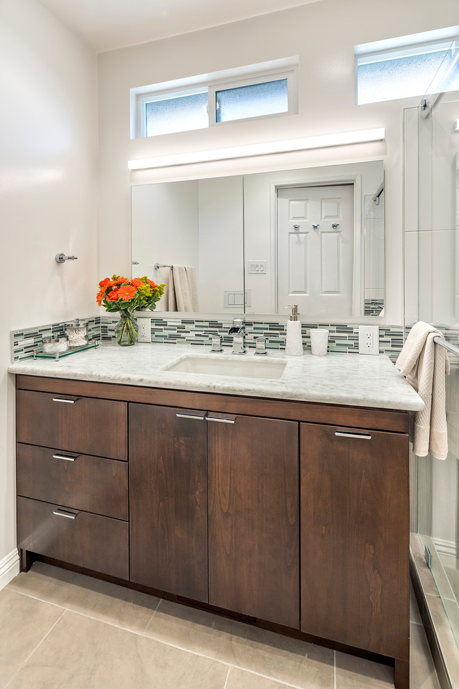 Inspiration for a mid-sized contemporary master multicolored tile and mosaic tile porcelain tile doorless shower remodel in San Francisco with an undermount sink, shaker cabinets, brown cabinets, quartzite countertops, a wall-mount toilet and white walls