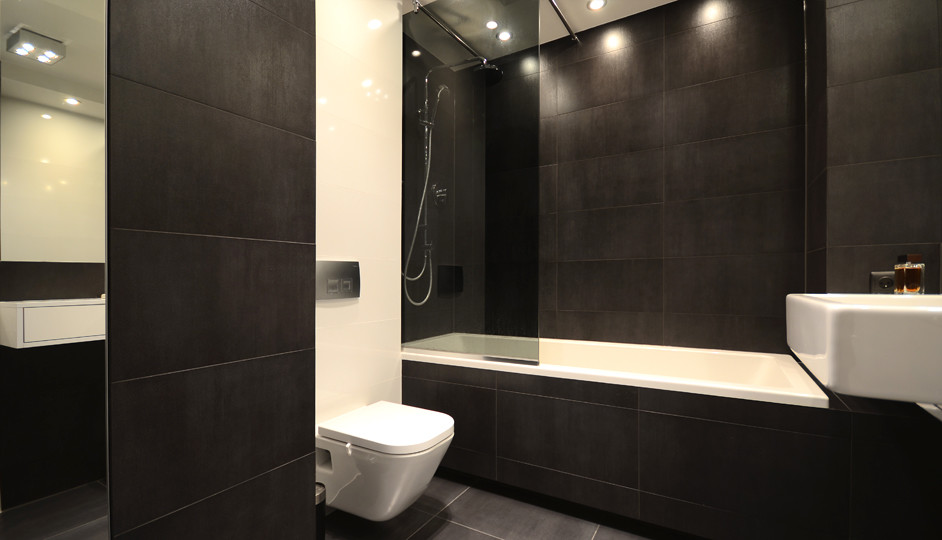 Example of a large minimalist master white tile and terra-cotta tile terra-cotta tile tub/shower combo design in Other with a drop-in sink, glass-front cabinets, a one-piece toilet and black walls