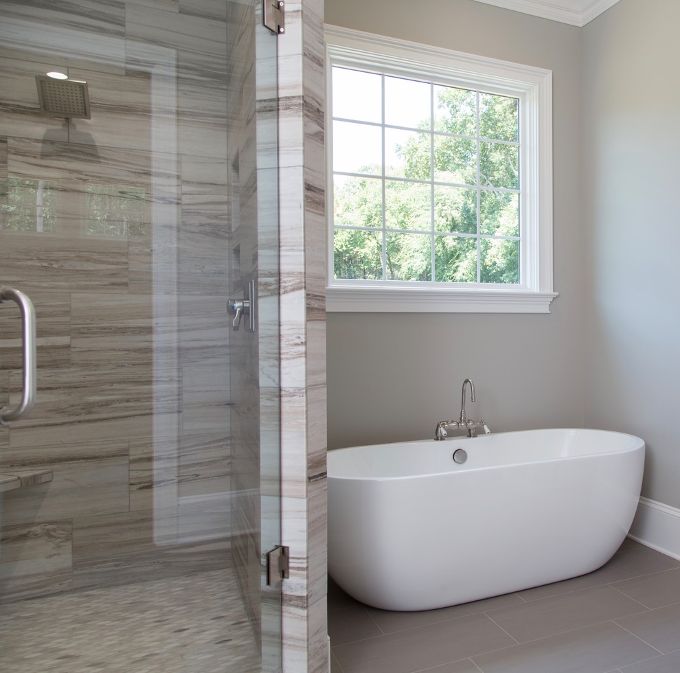 Large elegant master gray tile and porcelain tile porcelain tile and gray floor bathroom photo in Charlotte with recessed-panel cabinets, gray cabinets, a one-piece toilet, gray walls, granite countertops and a hinged shower door