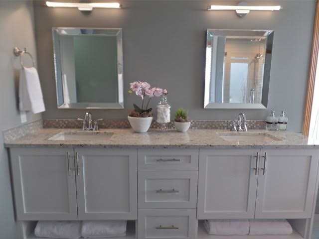 Medium sized traditional bathroom in Calgary with shaker cabinets, white cabinets, a freestanding bath, an alcove shower, beige tiles, ceramic tiles, blue walls, a submerged sink and granite worktops.