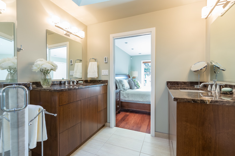 Photo of a medium sized contemporary ensuite bathroom in Vancouver with a submerged sink, flat-panel cabinets, medium wood cabinets, marble worktops, a corner shower, a two-piece toilet, beige tiles, porcelain tiles, green walls and porcelain flooring.